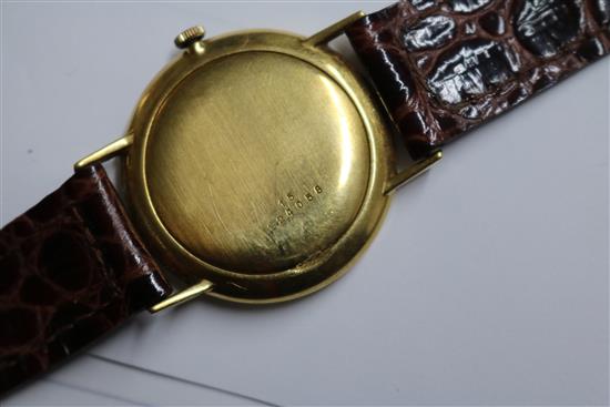 A gentlemans 18ct gold Longines manual wind wrist watch and a yellow metal Realm wrist watch.